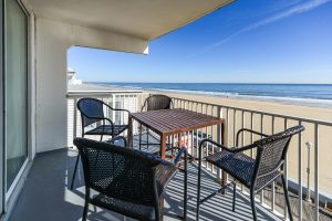 oceanfront balcony with table and chairs